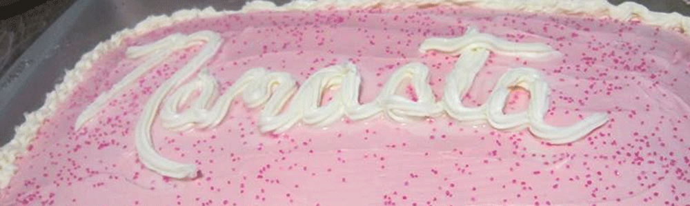 A pink cake with a message saying Namasta
