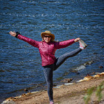 A woman standing on one foot while at Spooner Lake