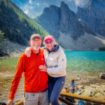 A couple taking a photo by the lake