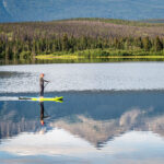 A person paddle boarding across Pyramid Lake