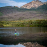 A person riding a paddle board in Pyramid Lake