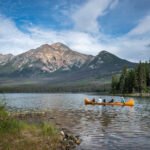 A group of people riding a boat across Pyramid Lake  