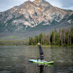 A woman doing a handstand on top of a paddle board in Pyramid Lake