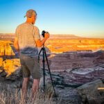 A man setting up a camera at Alstrom Point