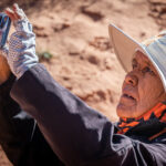 An old woman taking a photo of the Antelope Canyon