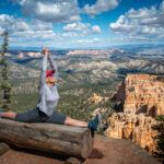 A woman doing a split while stretching her arns