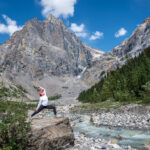 A woman stretching at the Emerald Lake shoreline