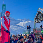 A performer wearing an orange jacket  