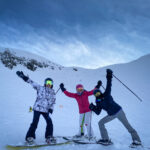 Three people having fun while skiing