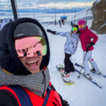 Skiiers wearing helmets with visors