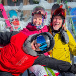 Three people in ski gear smiling  