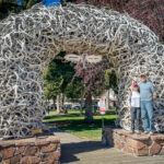 A man and woman at Jackson Hole’s Elk Antler Arch