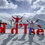 People posing in front of a sign of Val d’Isere