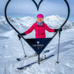 A woman posing in front of a heart