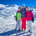 Three people on a ski slope