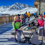 A group of people sitting on a picnic table