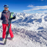 A person in ski gear on top of a mountain