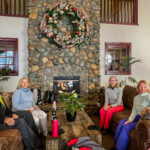 Four people sitting on couches at the lobby of a ski resort  