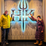 A couple in front of the Hell’s Kitchen logo