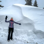 A woman in front of a pile snow