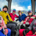 A family riding a ski cable car