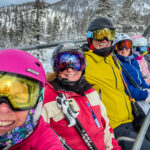 Six people riding a ski cable car