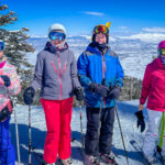 Four people about to ski  
