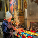 Lighting candles at the Chapel of Saint Bernard de Menthon  