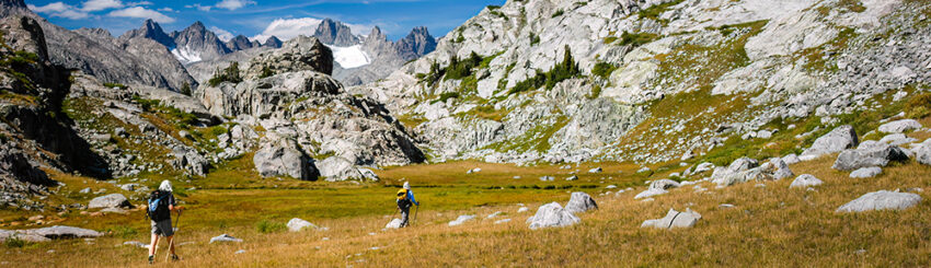 Two people climbing a mountain